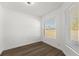 Empty bedroom with wood-look flooring and bright windows at 13404 Sw 60Th Court Rd, Ocala, FL 34473