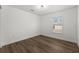 Spacious bedroom with wood-look flooring and large window at 13404 Sw 60Th Court Rd, Ocala, FL 34473