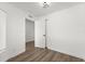 Spacious bedroom with wood-look flooring and an open door at 13404 Sw 60Th Court Rd, Ocala, FL 34473