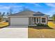 Newly constructed one-story home with attached garage and landscaped yard at 13404 Sw 60Th Court Rd, Ocala, FL 34473