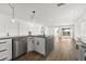 Modern kitchen with an island, stainless steel appliances, and white cabinets at 13404 Sw 60Th Court Rd, Ocala, FL 34473
