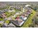 An aerial view of a single-story home in a neighborhood with winding streets at 203 Los Gatos Pl, Poinciana, FL 34759