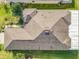 Aerial view showcases the home's roof, landscaping, and surrounding greenery at 203 Los Gatos Pl, Poinciana, FL 34759