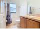 Bathroom with tub shower and wood vanity at 203 Los Gatos Pl, Poinciana, FL 34759