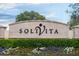 Solvita community entrance with landscaping and signage at 203 Los Gatos Pl, Poinciana, FL 34759