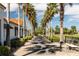 Landscaped walkway lined with palm trees leading through the community at 203 Los Gatos Pl, Poinciana, FL 34759