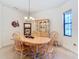 Bright dining room featuring a wooden table and hutch at 203 Los Gatos Pl, Poinciana, FL 34759