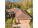 Beautiful home features a well-manicured lawn, paver driveway, and charming landscaping at 203 Los Gatos Pl, Poinciana, FL 34759