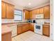 Modern kitchen with wood cabinets, stainless steel appliances, and tile floors at 203 Los Gatos Pl, Poinciana, FL 34759