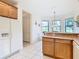 Spacious kitchen with a breakfast bar, lots of cabinets, and tile floors at 203 Los Gatos Pl, Poinciana, FL 34759