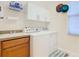 Laundry room with washer, dryer, and cabinets at 203 Los Gatos Pl, Poinciana, FL 34759