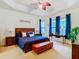 Large main bedroom with a ceiling fan, ample natural light, and wood furniture at 203 Los Gatos Pl, Poinciana, FL 34759