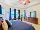 Luxurious main bedroom featuring a king bed, large windows, and a ceiling fan at 203 Los Gatos Pl, Poinciana, FL 34759