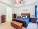 Spacious main bedroom with a king-size bed, ceiling fan, and walk-in closet at 203 Los Gatos Pl, Poinciana, FL 34759