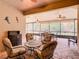 Relaxing screened lanai with seating area and ceiling fans at 203 Los Gatos Pl, Poinciana, FL 34759
