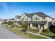 Tan townhome with gray roof, front porch, and landscaping at 2455 Varenna Loop # 1, Kissimmee, FL 34741