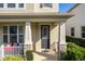 Front porch with gray door, white railing, and stone pillars at 2455 Varenna Loop # 1, Kissimmee, FL 34741