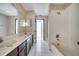 Clean bathroom with dual sinks, a bathtub, and tiled floors at 2650 Hilliard Ct, Kissimmee, FL 34744