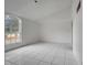 Simple bedroom with tile floors and a large window at 2650 Hilliard Ct, Kissimmee, FL 34744