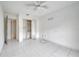 Bright bedroom featuring tiled floors, a built-in closet, and a ceiling fan at 2650 Hilliard Ct, Kissimmee, FL 34744