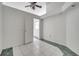 Empty bedroom with tile floor, ceiling fan, and a door to another room at 2650 Hilliard Ct, Kissimmee, FL 34744