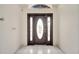 Interior image of an entryway with a dark brown door and tiled floor at 2650 Hilliard Ct, Kissimmee, FL 34744