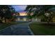 House exterior at dusk, showcasing a landscaped yard and driveway at 2650 Hilliard Ct, Kissimmee, FL 34744