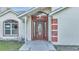 The front door has a stained wood finish with glass panels at 2650 Hilliard Ct, Kissimmee, FL 34744