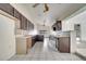Kitchen with dark wood cabinets, tiled floors and view into living area at 2650 Hilliard Ct, Kissimmee, FL 34744