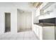 Dated kitchen with white cabinets and tiled floors, needs updating at 2650 Hilliard Ct, Kissimmee, FL 34744