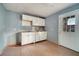 White kitchen cabinets, vinyl flooring, and exterior door at 2650 Hilliard Ct, Kissimmee, FL 34744