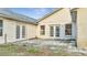 Home exterior showing a small patio area with double doors leading inside at 2650 Hilliard Ct, Kissimmee, FL 34744