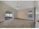 Main bedroom with sliding door to patio and ceiling fan at 2751 Stanwood Dr, Kissimmee, FL 34743