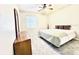 Bedroom with neutral walls, a ceiling fan, plush carpeting, and a large window for natural light at 2949 Zaharias Dr, Orlando, FL 32837