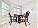 Charming dining area featuring tile flooring, a decorative light fixture, and large windows at 2949 Zaharias Dr, Orlando, FL 32837
