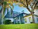 Stunning home with a large screened-in pool enclosure, green lawn, and mature trees at 2949 Zaharias Dr, Orlando, FL 32837