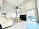 Bright living room with modern fireplace, high ceilings, and expansive sliding glass doors to the pool at 2949 Zaharias Dr, Orlando, FL 32837