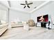 Cozy living room featuring wood-look flooring, a ceiling fan, and a large flat-screen TV at 2949 Zaharias Dr, Orlando, FL 32837