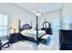 Spacious main bedroom with a four poster bed, ceiling fan, and large windows for ample natural light at 2949 Zaharias Dr, Orlando, FL 32837