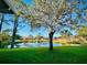 Serene pond view with mature trees and a fountain at 2949 Zaharias Dr, Orlando, FL 32837