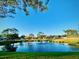 Scenic view of a serene pond with a fountain, surrounded by lush green landscaping at 2949 Zaharias Dr, Orlando, FL 32837