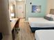 Guest room with two beds, work desk, and wood floors at 3000 Maingate Ln # 209, Kissimmee, FL 34747