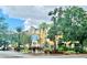 Hotel exterior with landscaping and signage at 3000 Maingate Ln # 209, Kissimmee, FL 34747