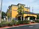 Hotel exterior featuring entrance and flags at 3000 Maingate Ln # 209, Kissimmee, FL 34747