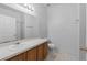 Neat bathroom with wood vanity, toilet and large mirror at 319 Sand Ridge Dr, Davenport, FL 33896