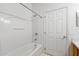 Bright bathroom with a tub shower combo and a door at 319 Sand Ridge Dr, Davenport, FL 33896