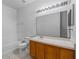 Clean bathroom with wood vanity and large mirror at 319 Sand Ridge Dr, Davenport, FL 33896