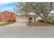 White house with red shutters and a two-car garage at 319 Sand Ridge Dr, Davenport, FL 33896