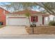 White house with red accents and a two-car garage at 319 Sand Ridge Dr, Davenport, FL 33896