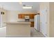 Kitchen with light wood cabinets and a breakfast bar at 319 Sand Ridge Dr, Davenport, FL 33896